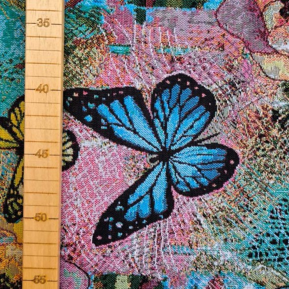Jacquard fabric AQUAMARINA with multicolored butterflies and blue background. Width 140